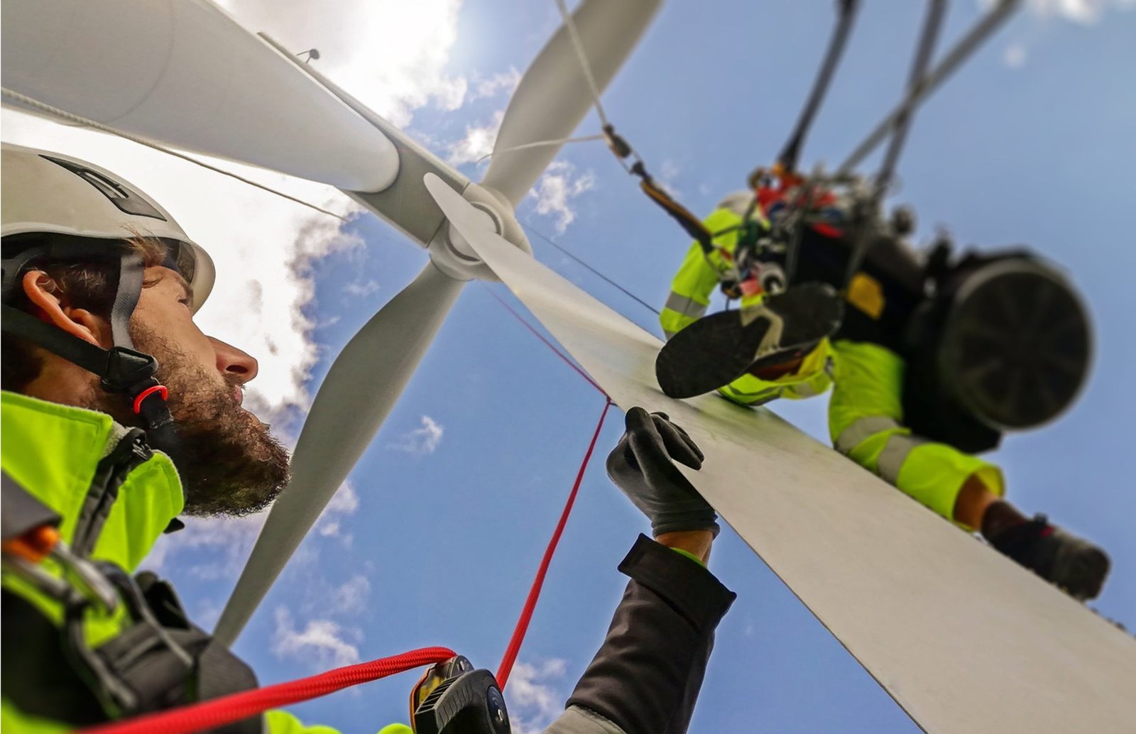 Rope access technicians working directly on a wind turbine rotor blade