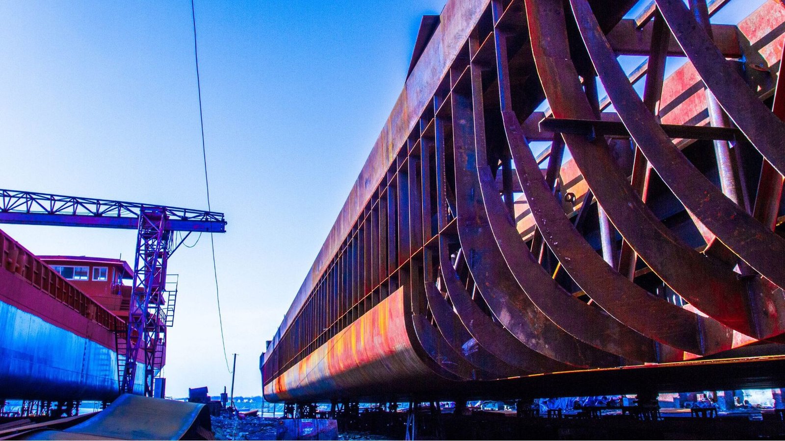 Ship hull steel structure under construction or repair at a shipyard.
